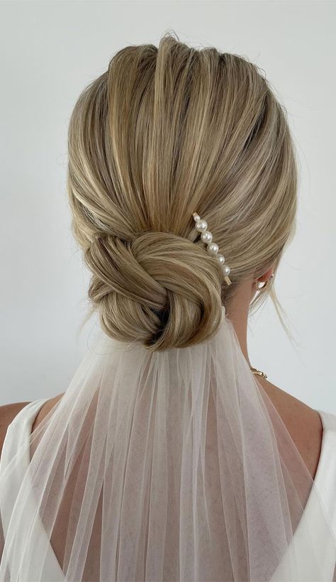 knot bun, knot bun hairstyle, wedding updos, wedding hairstyle, messy updo hairstyle for elegant look, messy updos, hairstyle ideas , updo, wedding updo hairstyle , 90s updos, textured updo, upstyle Wedding Upstyles With Veil, Wedding Dinner Hairstyle, Halterneck Wedding Dress Hairstyle, Low Bun Wedding Hair Accessories, Blonde Bridal Updo With Veil, Low Bun With Veil Underneath, Sleek Low Bun Bridal Hair With Veil, Wedding Updo For Straight Hair, Bride Messy Updo Hairstyles