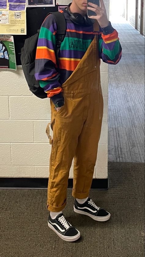 Outfit with khaki/brown/orange overalls and a colorful sweater with vans Sweater Overalls Outfit, Colorful Male Outfits, Colorful Masc Outfits, Overalls With Sweater, 90s Boys Fashion, Orange And Green Outfit, Indie Boy Outfits, Overalls Aesthetic, Overalls Men Fashion