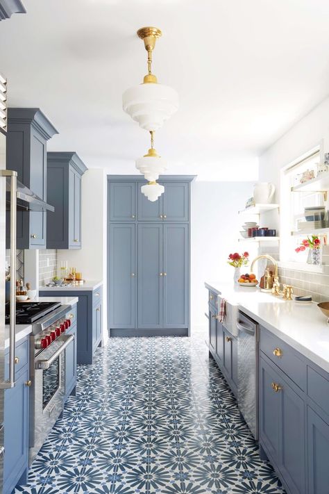 Moroccan interior design has its roots in the East, emphasizing fluid lines, contrasting vibrant hues, luxe fabric and, possibly the most defining characteristic of all, tile featuring geometric patterns which grace doorways, furniture, and floors. #hunkerhome #moroccan #kitchen #kitchenfloor #flooring #moroccantile Long Narrow Kitchen, Blue Kitchen Walls, Blue Kitchen Designs, Moroccan Kitchen, Interior Dapur, Narrow Kitchen, Blue Kitchen Cabinets, Floor Tile Design, Kitchen Paint Colors