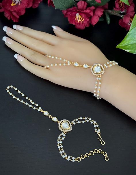 A pair of Gold finished Pearl bracelet/ Haathphool  /Hath Panja Ring Bracelet / hand harness/ Kundan Bracelet / Moissanite Baracelet Gold Hand Bracelet With Ring, Hath Panja, Finger Ring Bracelet, Hand Bracelet With Ring, Kundan Bracelet, Bracelet Combo, Finger Bracelets, Hand Harness, Crystal Wedding Jewelry