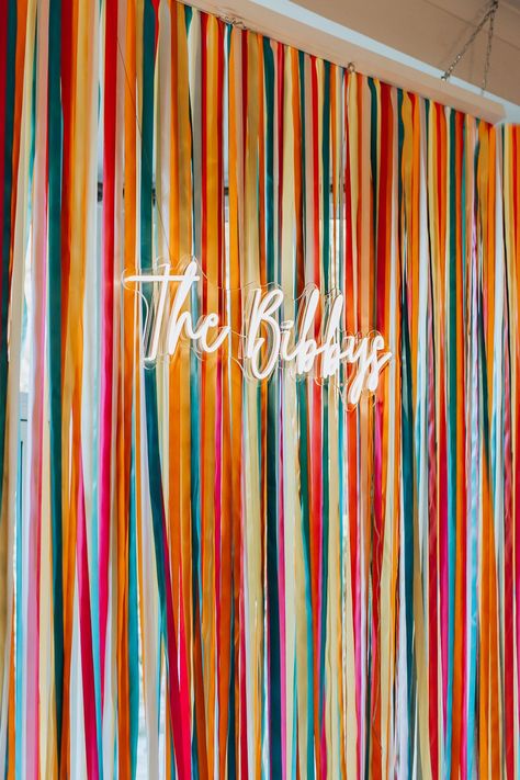 Photo Booth With Neon Sign, Wedding Backdrop For Photobooth, Neon Sign Backdrop Ideas, Ribbon Wedding Backdrop, Ribbon Wall Backdrop, Wall Decor For Wedding Reception, Ribbon Photo Backdrop, Creative Wedding Backdrop, Colorful Photo Backdrop