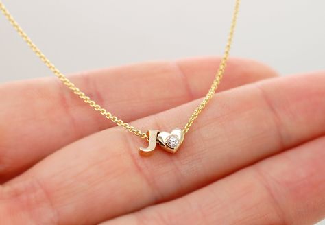 This solid gold letter J initial necklace. Letters are small, please swipe for the pictures for size reference. Could be made in 14K yellow, white and rose gold. If you are looking for a charm necklace, here: https://www.etsy.com/listing/534422198/14k-gold-letter-necklace-tiny-initial Charm bracelet: https://www.etsy.com/listing/465584610/add-on-initial-bracelet-14k-gold-letter All letters, a heart and a star are available, just write down which ones you need in the comment section of the order. Letter J Necklace Initials, A Initial Jewelry, J Necklace Initial, J Letter Necklace, J Bracelet, J Initial Necklace, J Name, Letter J Necklace, J Ring