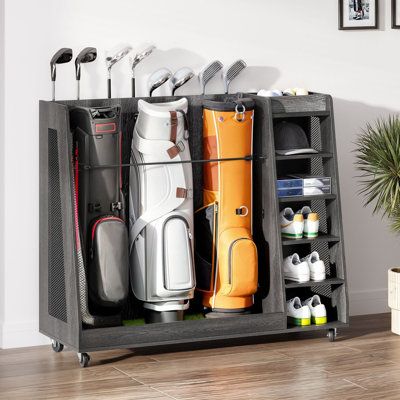 Organize your golf gear with ease using our large-capacity golf organizer. It holds 2 - 3 bags, balls, shoes, and accessories, while securely storing up to 5 clubs (white) or 8 clubs (black). Crafted from premium wood and metal, this rack is perfect for garages, homes, clubs, or basements. With 360° swivel wheels, it's easy to move around, and the included turf mat and elastic strap protect your bags. Ideal for golfers, it measures 35.4" L x 17.7" W x 40.15" H (White) or 47.24" L x 17.7" W x 40. How To Store Chairs In Garage, Garage Organization Golf Clubs, Diy Golf Club Storage, Sport Storage Ideas, Golf Organization Garage, Golf Storage In Garage, Garage Golf Storage, Golf Club Storage Garage, Golf Storage Ideas