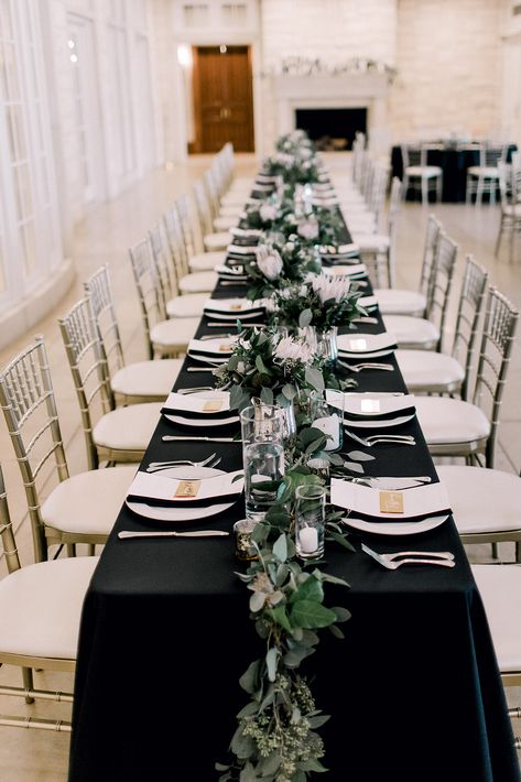 Black Green Tablescape, Table Decor With Black Tablecloth, Black Rehearsal Dinner Decor, Black Long Tables Wedding, Eucalyptus And Black Table Decor, Table Setting Black Tablecloth, Black Tablecloth Wedding Receptions, Black Tablecloth With Greenery, White And Black Dinner Party