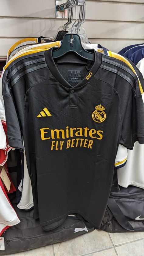 The Kitman - Football kit news from La Liga in Spain as leaked images of the new Real Madrid 2023-24 Adidas third shirt have appeared online. The leaked 2023-24 Real Madrid third shirt is predominantly black with dark grey Adidas stripes on the shoulders. Both the Adidas logo on the right breast and the Real Madrid crest on [...] The post Real Madrid 2023-24 Adidas Third Shirt Leaked appeared first on The Kitman - Old, Classic, Vintage & Retro Football Shirts & Football Kits. Real Madrid 3rd Kit, Real Madrid Crest, Real Madrid Shirt, Cristiano Ronaldo Manchester, Football Jersey Outfit, Chic Dress Classy, Adidas Jersey, Retro Football Shirts, Soccer Outfits