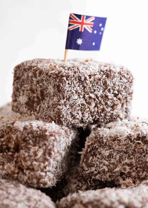 Pile of Lamingtons with an Australian flag Australian Lamingtons Recipes, Lamingtons Recipe Australia, Lamingtons Recipe, Australia Recipes, Australian Recipes, Coconut Icing, Australian Icons, Aussie Food, Pie Party