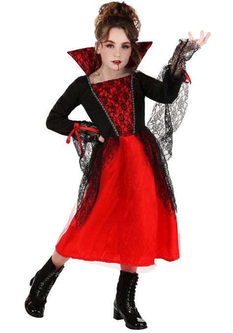 Transform into the royalty of the night with our exclusive Girl's Regal Vampire Costume Dress. This elegant and mysterious ensemble captures the timeless charm of a vampire! Features: 100% polyester Pullover red satin dress has red tulle overlay on the skirt of the dress Foam backed stand up satin collar has black lace layer Jersey knit black top of dress has shimmery trim, lace front and lace sleeve ends with a satin red bow Dress has an elastic waist back and lace sewn in the hips of the dress Exclusively made by usIncludes the following: Dress Please view our Return Policy details at http://stores.ebay.com/halloweencostumescom/Return-Policy.html. Vampire Features, Red Bow Dress, Red Satin Dress, Vampire Costume, Lace Layers, Theatre Costumes, Bow Dress, Red Satin, Red Bow