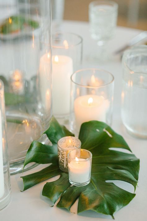 Tropical Candle Centerpieces Wedding, Tropical Diy Centerpieces, Elegant Tropical Party Decor, Tropical Leaves Centerpiece, Tropical Rehearsal Dinner Decorations, Tropical Engagement Party Ideas, Cheap Tropical Centerpieces, Old Florida Party Theme, Tropical Cocktail Table Decor