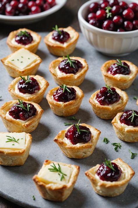 A photo of a  Cranberry Brie Bites which is a type of thanksgiving appetizers Fancy Fall Appetizers For Party, Brie Appetizer Thanksgiving, Mini Brie Bites Recipes, Thanksgiving Brie Recipes, Thanksgiving Cold Appetizers, Brie And Cranberry Appetizer, Light Thanksgiving Appetizers, Stuffing Appetizer, Thanksgiving Hors D’oeuvres