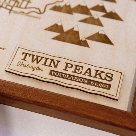 ✨ Discover the Magic of Twin Peaks! ✨ Unveil our unique Twin Peaks-themed wooden epoxy map, handcrafted by a local artist. Featuring iconic landmarks like the Great Northern Hotel and Ronette’s Bridge, each piece is a unique work of art. Order now and bring the spirit of Twin Peaks to your home! 🏔️🪵 #twinpeaks #bookhouseboys Nfl Stadium, Wooden Epoxy, Nfl Stadiums, Wood Epoxy, Unique Maps, Wooden Map, Illustrated Map, Twin Peaks, City Maps