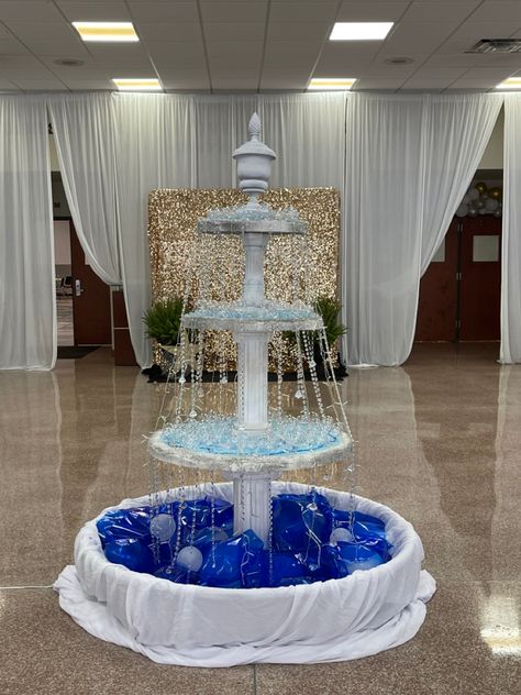 Made from a small pool, balloons, styrofoam, lights, crystals, clear Christmas balls in different sizes and a finial on top. Cardboard Fountain Prop, Royal Prom Decorations, Fake Fountain Prop, Greece Hoco Theme, Greek Hoco Theme, Greek Homecoming Theme, Greek Theme Prom, A Night In Greece Prom Theme, Italy Prom Theme