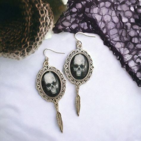 https://www.etsy.com/listing/1379091360/skull-earrings-gothic-gift-for-her 💀🖤 Embrace the dark allure with our Metallic Skull Feather Gothic Earrings! These occult witchcraft earrings for women are more than just accessories—they're statements of gothic beauty and mystique. With their metallic skull and feather design, they exude an aura of dark style and sophistication, making them perfect for lovers of gothic jewelry and spooky accessories. 🌙🔮 Let these earrings serve as a symbol of your ... Spooky Accessories, Pagan Symbols, Earrings Gothic, Gothic Gifts, Alternative Jewelry, Dark Style, Gothic Earrings, Gothic Beauty, Feather Design