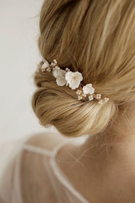 Delicate and stunning floral comb is crafted with handmade Porcelain flowers and small matte beads. Use this flower hair comb to accentuate an updo or add a whimsical touch to loose waves. So small the comb is well attached and holds even on short hair (if necessary, it can be fixed with a bobby pin). This bridal hair piece is versatile and can complement any wedding gown design. Available on silver and gold wire. Length: 9 cm ( 3.5 inch) If you like this bridal hair comb, I recommend that you s Bridal Hair With Hair Comb, Bridal Hair Accessories Updo, Wedding Bun With Flowers, Low Bun Wedding Hair With Flowers, Flower In Hair Wedding, Gold Hair Piece Wedding, Boho Wedding Hair Flowers, Flower Head Piece, Bride Hair Comb