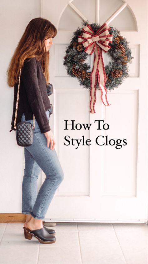 Woman wearing a black sweater straight jeans and clogs Styling Clogs 2022, Wedge Clogs Outfit, Clog Skirt Outfit, Black Platform Clogs Outfit, How To Wear Clogs 2022, Outfits With Clogs Spring, Wide Leg Jeans And Clogs Outfit, Brown Clog Outfit, Outfits With Black Clogs