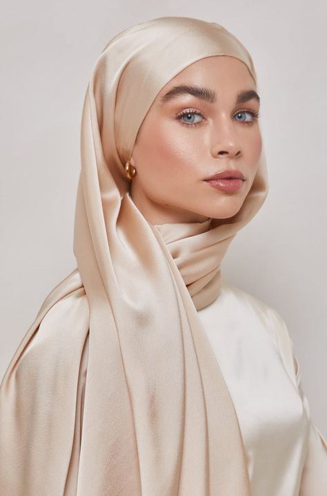 This satin hijab feature a smooth high shine satin fabric with a subtly textured backing to prevent slippage. Pair with your favorite evening attire, gold jewelry and an effortless magnet pin for a timeless look. Measurements Standard: approx. 180 cm x 70 cm (70" x 27") Petite: 180 x 45 cm (70" x 17") - this size is appropriate as a hijab for small children or for wrapping as a shawl or body coverup Material 100% Satin Polyester Model With Hijab, Hijab High Fashion, Gold Hijab Outfit, Satin Hijab Style, High Fashion Hijab, Hijab Photoshoot Ideas At Home, Hijabi Girl Hidden Face, Hijabi Girl Cartoon, Satin Shawl Hijab