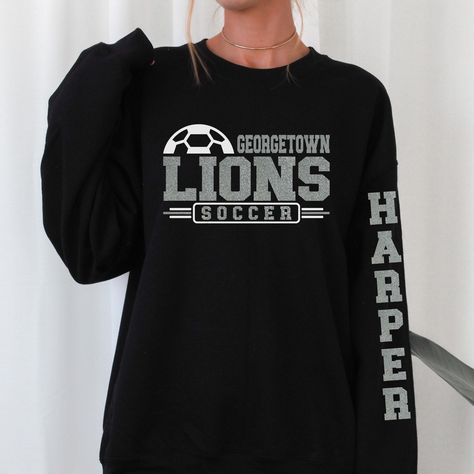 Customize this Soccer spirit wear with your mascot's name & team colors, then on the sweater sleeve is the player's first name, and then finally on the back is the last name and player number. This design is a great gift for friends, family, co-workers, or yourself. Listing is for one garment. To order... 1. Select the style and size you would like, then the color for the garment. 2. Fill out the personalization section. 3. Then add to cart. To order more than one item of the same style, size, a Soccer Spirit Wear, High School Soccer Shirts, Soccer Captain, Soccer Shirts Designs, Soccer Clothes, Homemade T Shirts, Soccer Team Shirts, Soccer Ideas, Team Sweatshirts