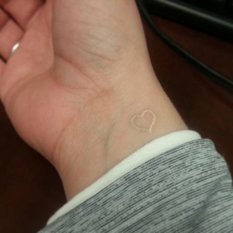 White tattoo. Love it. I want a tattoo on my wrist with the word strength in script Small White Tattoos, White Heart Tattoos, Small Heart Tattoo, Heart Tattoo Wrist, White Tattoos, Tattoo Wrist, White Ink Tattoo, Small Tattoos With Meaning, Small Tattoos For Guys