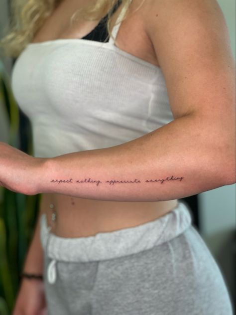 Cursive Arm Tattoos For Women, Arm Saying Tattoos For Women, Cute Quotes For Tattoos, Quote Tattoos For Women Arm, Expect Nothing Tattoo, Side Arm Tattoos For Women Small, Bicep Tattoo Women Quotes, Forearm Writing Tattoo Women, Tattoo Ideas Female Writing