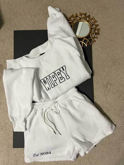 Are you a newlywed or celebrating your love journey? Our personalized "Wifey" Sweatshirt and short set is the ultimate blend of comfort and chic.   The shorts are customized with an "est 202X" year to showcase the special occasion. Embroidered.  Will not fade    NOW AVAILABLE IN SHORT SLEEVES -message me for details  #Bride #wifey #honeymoon #bacheloretteparty #Forthebride Bridal Party Airport Outfit, Bride Plane Outfit, After Reception Outfit Brides Comfy, Bride Comfy Outfit, Bride Sweat Set, Bride Sweat Suit Wedding Day, Comfy Getting Ready Outfit Wedding, Wedding After Party Outfit Sweats, Matching Wedding Sweatsuits