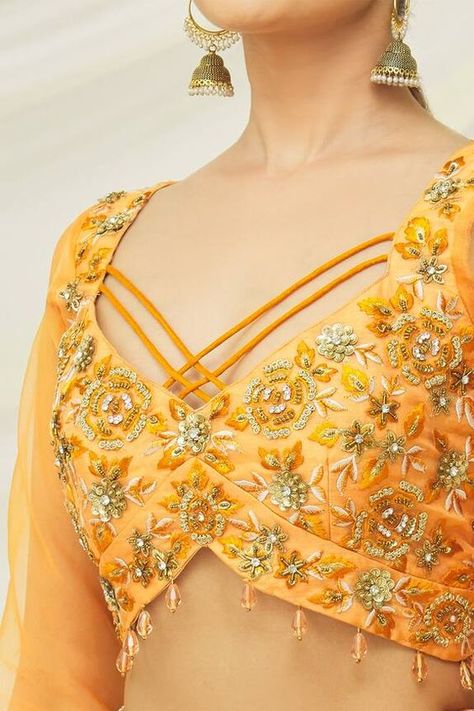 Mustard raw silk padded crop top with floral and sequins embroidery. Comes with an organza lehenga with mirror and thread embroidery and a georgette choker dupatta.
Component: 3
Pattern: Embroidered
Type Of Work: Floral, Sequins, Mirror, Thread
Neckline: Leaf Neck
Sleeve Type: Full
Fabric: Crop Top : Raw silk, Lehenga : Raw silk and Organza, Dupatta : Georgette
Color: Yellow
Other Details: 
Circle back cut-out on crop top
Embroidered patch on dupatta
Attached cancan
Closure : Side-tasseled tie-u Blouse Front Design Neckline, Trendy Front Neck Blouse Designs, Crop Top And Lehenga, Choker Dupatta, Top And Lehenga, Motorcycle Festival, Sari Blouses, Blouse Tops Designs, Organza Lehenga