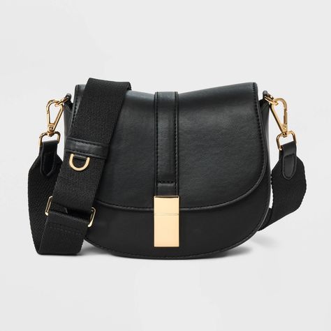 This Saddle Crossbody Bag from A New Day™ with a structured silhouette features a roomy main compartment and an interior zip pocket for easy organization of your belongings, plus an overlapping flap with a gold-tone buckle accent and magnetic closure. Plus, the detachable adjustable shoulder strap makes carrying a breeze whether you sling it over one shoulder or carry it in hand. A New Day™: Style that goes wherever you do. Target Purse, Minimalist Purse, Purse Aesthetic, Saddle Crossbody Bag, Black Crossbody Bag, Black Crossbody Purse, Top Handle Handbags, Black Purse, Crossbody Messenger Bag