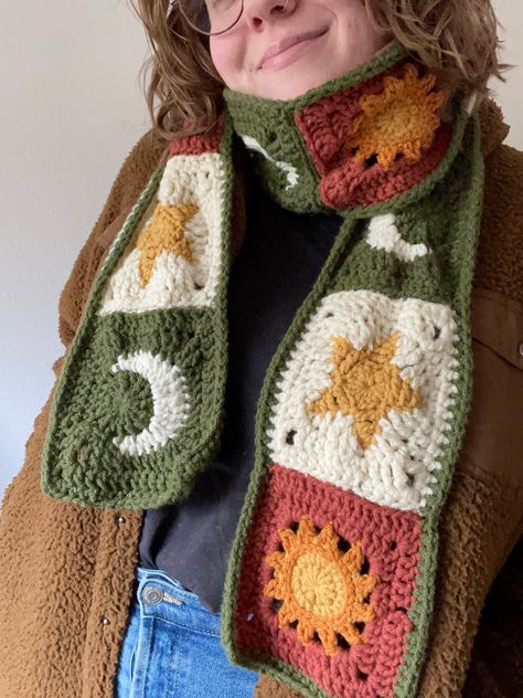 Crochet sun, moon, and star granny square scarf! This long celestial granny square scarf is completely handmade by me! Granny Square Patterns by AlyssiaCreates . All yarn used is soft acrylic in the colors pumpkin, mustard, ginger, off-white, and leaf green. The finished scarf is about 68" x 5.5" WHAT TO EXPECT - One celestial sun, moon, and star granny square scarf! - Protective packaging so the scarf doesn't get damaged during shipping. - Shipping through USPS! SHIPPING All items are handmade to order and shipped out by me, therefore it can take me 5-7 days to get an item in the mail. Once shipped all items should arrive approximately within 2 weeks, all dependent on the USPS Mailing system. DISCLAIMERS AND NOTES -All items are handmade by me at home. -The granny square patterns are by A Cool Crochet Scarves, Things Made From Granny Squares, Crochet Bird Granny Square, Crochet Cloud Granny Square, Pumpkin Crochet Square, Crochet Scarf Squares, Monstera Leaf Granny Square, Crochet Scarf Fall, Star Scarf Crochet