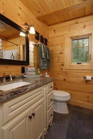 log home bathroom, small bathroom deesigns, oil rubbed bathroom cabinet, tongue & groove ceiling, white pine finishes in bathroom, small log cabin in the woods, small log cabin, small log home, log homes, log home with porch, cozy log home, log home with black roof, Timberhaven log homes, engineered log homes, log home designs Log Home Bathrooms, Log Home Bathroom, Small Log Homes, Log Cabin Floor Plans, Timber Homes, Log Home Designs, Small Log Cabin, Cabin Bathrooms, Log Home Decorating