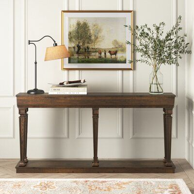 If you're seeking an occasional table with a streamlined presence, this sofa table will be the perfect piece to pick. The table fits nicely in the entry or living room. A solid wood frame with a warm oak finish blends easily in any living space. Display your collectibles and more on the bottom shelf. Size: 35" H x 72" W x 12" D | Lark Manor™ Constableville Console Table Wood in Black, Size 35.0 H x 72.0 W x 12.0 D in | Wayfair Decorative Console Table, 72” Console Table, Antique Sofa Table Behind Couch, Console Table With Two Lamps, Vintage Entryway Table Decor, How Long Should A Sofa Table Be, Console Table With Art Above, Entry Table Under Window, Vintage Console Table Decor