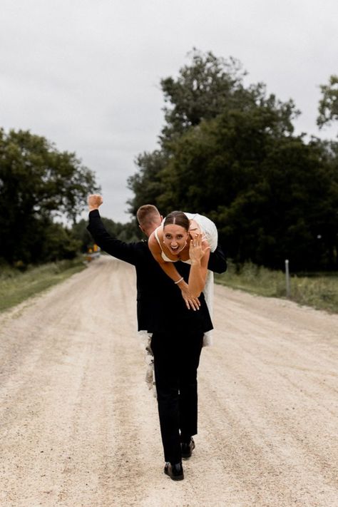 Groom walks away carrying bride over his shoulder as he celebrates with a fist in the air while bride flashes a smile and shows off her stunning wedding ring. Unique Wedding Poses, Fun Wedding Pictures, Wedding Photo List, Bride Groom Poses, Groom Photoshoot, Wedding Portrait Poses, Bride Groom Photos, Wedding Couple Photos, Creative Wedding Photo