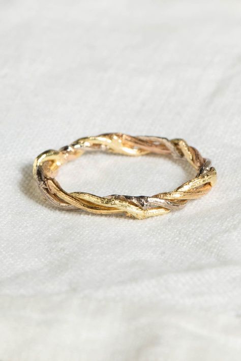 A nature-inspired treasure, this handmade ring features three woodland twigs, each crafted from contrasting 18ct gold in yellow, white, and rose. Twisted together like intertwining vines, these precious pieces evoke the serenity of a woodland walk. A perfect alternative wedding band for nature lovers, this organic design offers a unique and timeless connection to the natural world. Nature Inspired Ring, Twig Rings, Woodland Wedding Ring, Jewellery Portfolio, Twisted Rings, Gold Twig Ring, Alternative Wedding Ring, Nature Wedding Ring, Butterfly Necklace Silver