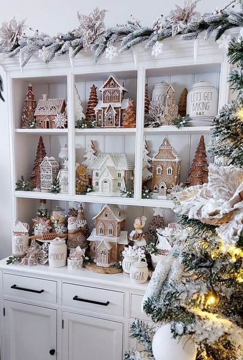 Get ready to step into a scrumptious holiday wonderland with my 30 Gingerbread Christmas decor ideas! From simple touches to grand statements, these ideas will fill your home with festive cheer and sweet, cozy vibes. Grab a hot cocoa, and start discovering your next holiday inspiration! Neutral Christmas Village Display, Village Houses Christmas, Christmas Rae Dunn Hutch, White Christmas Tree Gingerbread Theme, Neutral Christmas Village, Vintage Gingerbread Decor, Neutral Gingerbread Display, Gingerbread Christmas Display, Rustic Gingerbread Decor