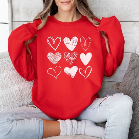 Valentine Hearts Sweatshirt, Cute Valentine Sweatshirt, Teacher Valentine Sweatshirt, Love Sweatshirt, Valentines Day Shirt, Love Shirt Valentines crewneck with 9 white hearts Available in black, maroon, military green, forest green, dark heather, navy, purple, heliconia and red Made with a medium-heavy fabric blend of 50% cotton and 50% polyester Sizes are small through 3XL (more details on sizing can be found in the listing photos) CARE INSTRUCTIONS Machine wash on cold (max 30C or 90F) Tumble dry on low heat DO NOT iron, dry clean, or bleach Please message me if you have any questions, and thank you for checking out my shop! Valentines Day Sweatshirt, Valentine Sweatshirt, Love Sweatshirt, Couples Sweatshirts, Heart Sweatshirt, Sweatshirt Fabric, Heart Shirt, Valentines Day Shirts, Valentine Day Love