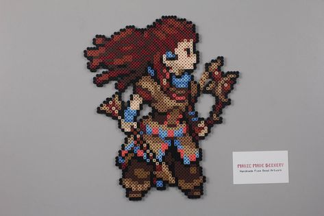 Perler Bead Aloy inspired by Horizon Zero Dawn Each sprite is made to order and comes with your choice of mounting material. Finishing tacks or nothing at all! Aloy measures roughly 11.50 to 9.75 tall and wide. PS3 controller for size comparison. If you have any questions please Modele Pixel Art, Pokemon Bead, Pixel Beads, Art Perle, Perler Bead Templates, Bead Sprite, Diy Perler Beads, Iron Beads, Perler Beads Designs