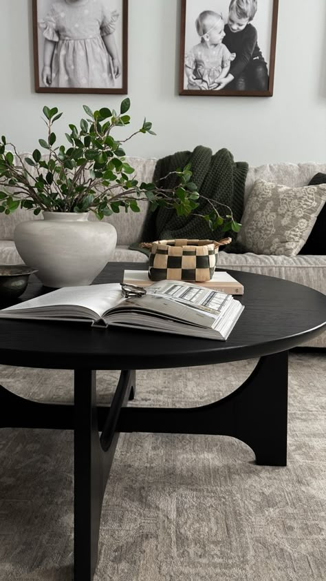 Black Coffee Table Circle, Black Coffee Table Living Room Decor, Black Rustic Coffee Table, Black Round Coffee Table Styling, Black Living Room Table Decor, Styling Black Coffee Table, Round Black Coffee Table Decor, Black Wood Coffee Table Living Room, Black Coffee Table Aesthetic