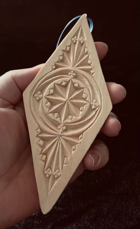 24010 Wooden Chip Carved Diamond Ornament is hand carved in fine basswood.  The design is based on the Frisian (Or Northern Netherlands, or "Old World") style of chip carving It has a natural wood grain finish of clear lacquer and hand rubbed paste wax.   It's approximate size is 6.75 inches tall, 3 inches wide, and .375 inches thick. It has a metal Screw eye and cloth ribbon installed on the top to facilitate hanging. Add this ornament to your collection or start a tradition of exchanging hand Wood Cravings Design, Mexican Wood Carvings, Chip Carving Patterns Free, Wood Carved Christmas Ornaments, Chip Carving Patterns, Ornamental Wood Carving, Art Sculpture En Bois, Whittling Patterns, Wood Cnc Machine