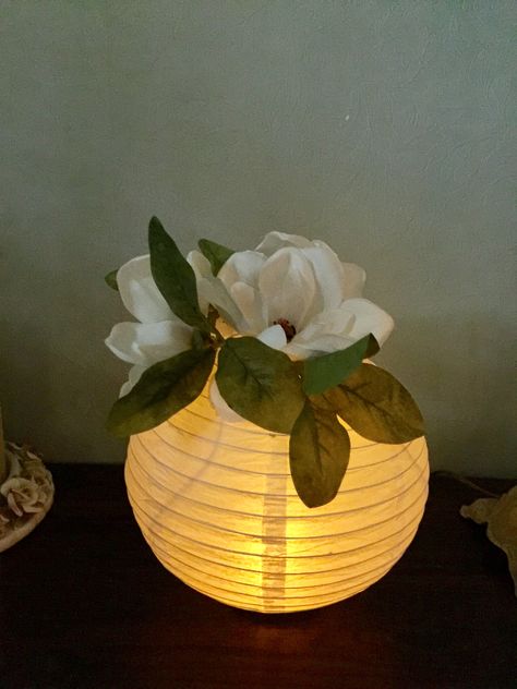 We used paper lanterns with a LED  tea light for centerpiece's at our class reunion. We hot glued a wide mouth bell jar lid on the bottom for a base so it would stand on the table. We used silk magnolias on the top to fill the hole. Paper Lantern Centerpieces, Princess Tiana Birthday Party, Diy Paper Lanterns, Centerpieces For Weddings, Tiana Birthday Party, Class Reunion Decorations, Reunion Decorations, Paper Lanterns Diy, Deco Champetre