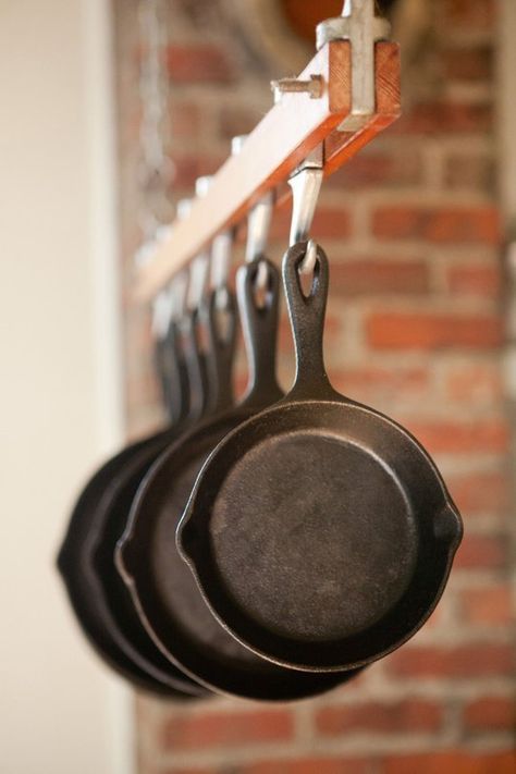 10 Kitchens With Cast Iron Pans on Display Kitchen Inspiration | The Kitchn How To Hang Cast Iron Pans, Cast Iron Pans Storage, Cast Iron Skillet Hanger, Cast Iron Skillet Organization, Hanging Cast Iron Skillets On Wall, Iron Skillet Display, Hanging Cast Iron Pans, Cast Iron Skillet Storage Ideas, Cast Iron Cookware Display