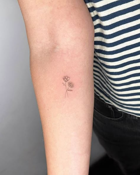 Fine line style flowers tattooed on the inner forearm. Fine Line Daisy And Rose Tattoo, Daisy Dainty Tattoo, Pansies Flower Tattoo, Daisy And Poppy Tattoo Small, Tulip And Daisy Tattoo, Daisy And Narcissus Tattoo, Daisy And Daffodil Tattoo, Poppy And Daisy Tattoo, Daisy Fine Line Tattoo