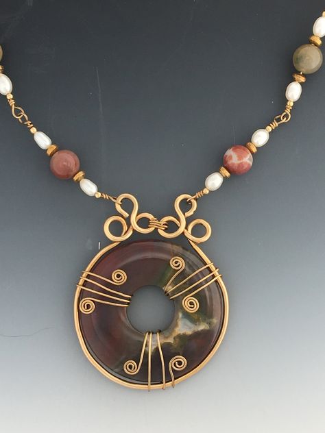 "BP34- Fancy Jasper Donut Necklace made with Yellow Gold Filled Wire. Pendant measures 1 3/4\" across the necklace part is made with Jasper beads, Fresh water pearls and YGF beads with YGF Long and short chain. Comes with a heavy Lobster Claw Closure and it measures 16\" in length which would make it Choker length. All of my pieces are one of kind and made by me. If you would like to know more please go to my website at: www.denimanddiamondjewelry.com Thanks for looking, and feel free to contact Donut Necklace, Metal Art Jewelry, Fancy Jasper, Board Pin, Badass Style, Wire Necklace, Fresh Water Pearls, Wire Pendant, Water Pearls