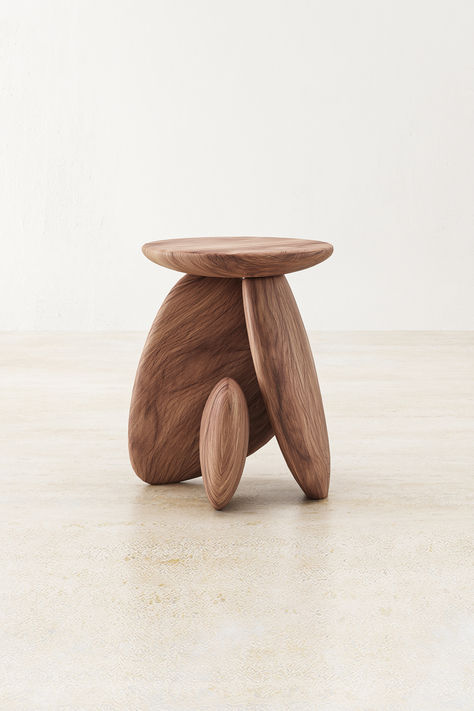 Crafted from the esteemed Raintree wood, the Pebble Side Table is a masterpiece of natural allure and sophistication. Its surface, inspired by the smooth contours of river stones, provides a tactile experience as refined as its appearance. Below, three elegantly carved legs, reminiscent of the pebbles that grace serene brooks, form a tripod base that ensures both stability and a visually pleasing aesthetic. Side Table Base Ideas, Three Legged Side Table, Pebble Side Table, Luxury Wood Furniture, Wood And Stone Table, Organic Shape Furniture, Natural Furniture Design, Aesthetic Wood Furniture, Japandi Side Table