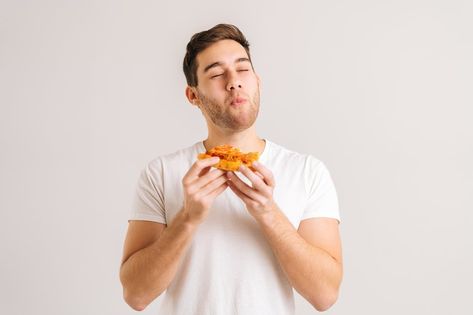 Portrait of handome young man with enjoying eating delicious slice of pizza, with closed eyes from pleasure on white isolated background. Studio shot of hungry male student eating tasty food. Dnd Western, Cookies Packaging, Man Eating, Fire Horse, Slice Of Pizza, Background Studio, Couples Hugging, Baby Blue Aesthetic, Male Eyes