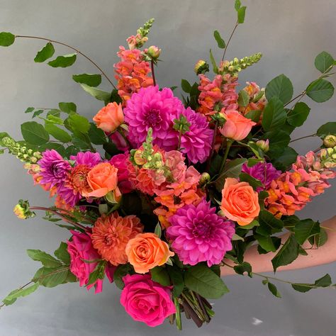 Summertime - we love pink and orange its one of our favourite colour combos, its uplifting, a little wild and hugely enjoyable . A bright and celebratory bouquet inspired by summer sunsets ,most loved by clients Usually contains roses, dahlias, snapdragons, and statement foliage when available Wedding Bouquets Colorful Summer, Bright Flowers For Wedding, Bright Summer Flowers Wedding, Bright Flower Bouquet Wedding, Orange And Pink Floral Arrangements, Pink And Orange Wildflower Bouquet, Bright Pink Flower Bouquet, Bright Pink And Orange Wedding Flowers, Neon Flower Bouquet