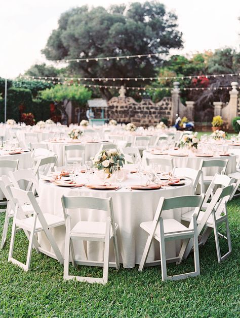 Guest tables with White Resin Chairs (66" round tables with Ivory linens and Peach napkins) White Table White Chairs Wedding, Wedding Table White Chairs, White Table And Chairs Wedding, Backyard Wedding Round Tables, Ivory Table Linens Wedding, White Resin Chairs Wedding, Wedding Ceremony White Chairs, White Chairs Wedding, Yucatan Wedding