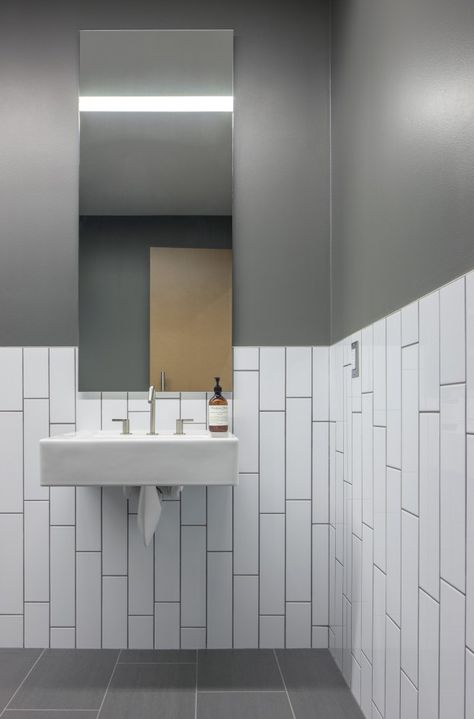 bathroom. long subway tile, vertical running bond, chair rail - Bicycle Haüs / Debartolo Architects Commercial Bathroom Designs, Toilette Design, Ideas Baños, Restaurant Bathroom, Subway Tiles Bathroom, Restroom Design, Best Bathroom Designs, Bathroom Installation, White Subway Tiles