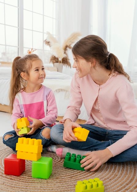 Free photo front view of two sisters pla... | Free Photo #Freepik #freephoto #family-playing #family-together #siblings #family-home Family Playing, Play Structure, Two Sisters, Front View, Stock Pictures, Family Pictures, Vector Photo, Family Photo, Free Photo