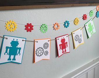 Each Kit Includes: Robot Bunting Banner (approx. 40 inches) Gear Garland (approx. 42 inches) Robot Friends Garland (approx. 30 inches) Be sure to check out our other themes! Diy Robot Decorations, Organic Robot, Robot Birthday Party Decorations, Robot Decorations, Robot Birthday Party, Robot Theme, Luau Decorations, Wizard Party, Robot Party