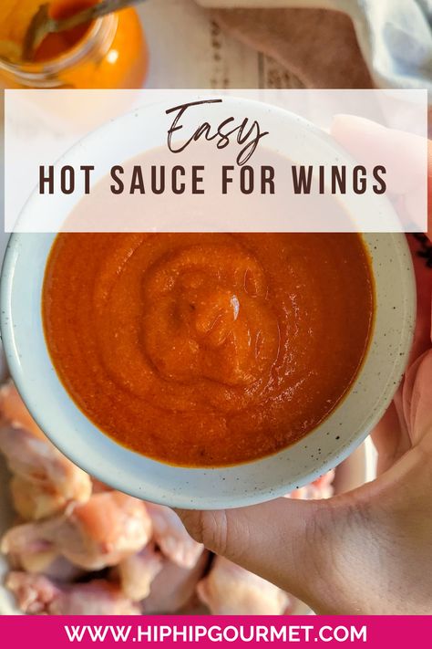 hand holding a bowl of red sauce over a plate of raw chicken wings Homemade Hot Wings, Hot Wing Sauce Recipe, Hot Wing Sauce, Homemade Wings, Chicken Wing Sauce Recipes, Hot Chicken Wings, Hot Sauce Recipe, Hot Wing Sauces, Wing Sauce Recipes