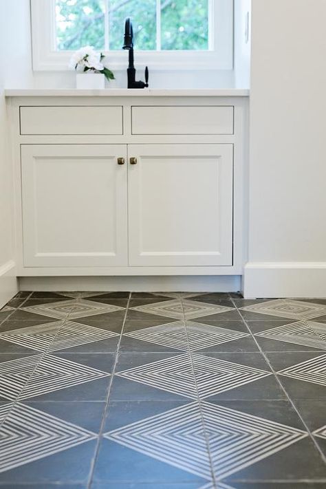 Beautiful gray and white laundry room features white and gray diamond pattern floor tiles leading to white cabinets fitted with brass knobs and a white countertop finished with a sink and an oil rubbed bronze gooseneck faucet positioned in front of a window. Laundry Room Tile, White Laundry Rooms, White Laundry, Patterned Floor Tiles, Room Tiles, Laundry Mud Room, White Countertops, Tile Flooring, Bathroom Floor Tiles