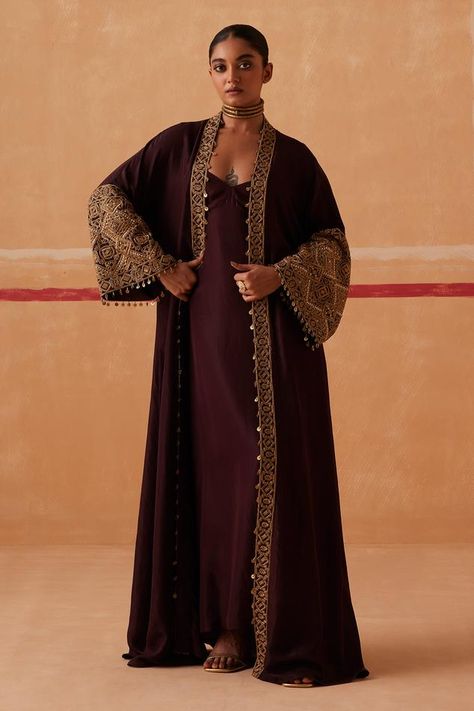 Brown bell sleeve long kimono cape, highlighted with placement zardozi embroidery. Paired with an inner kaftan. Components: 2 Pattern: Placement Embroidery Type Of Work: Zardozi Neckline: Kaftan: V Neck Sleeve Type: Kimono: Bell Sleeves Fabric: Habutai Silk Color: Brown Other Details:  Length: Cape: 56 inches Kaftan: 52 inches Occasion: Sangeet - Aza Fashions Sureena Chowdhri, Paulmi And Harsh, Brown Kimono, Embroidery Zardozi, Placement Embroidery, Silk Drapes, Kaftan For Women, Dramatic Sleeves, Zardozi Embroidery