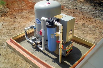 Well Houses, Remotes, and Buried Systems | Miller Well Drilling Well Pump House, Grey Water System Diy, Water Well House, Well Pressure Tank, Well Water System, Submersible Well Pump, Barrels Diy, House Plumbing, Well House